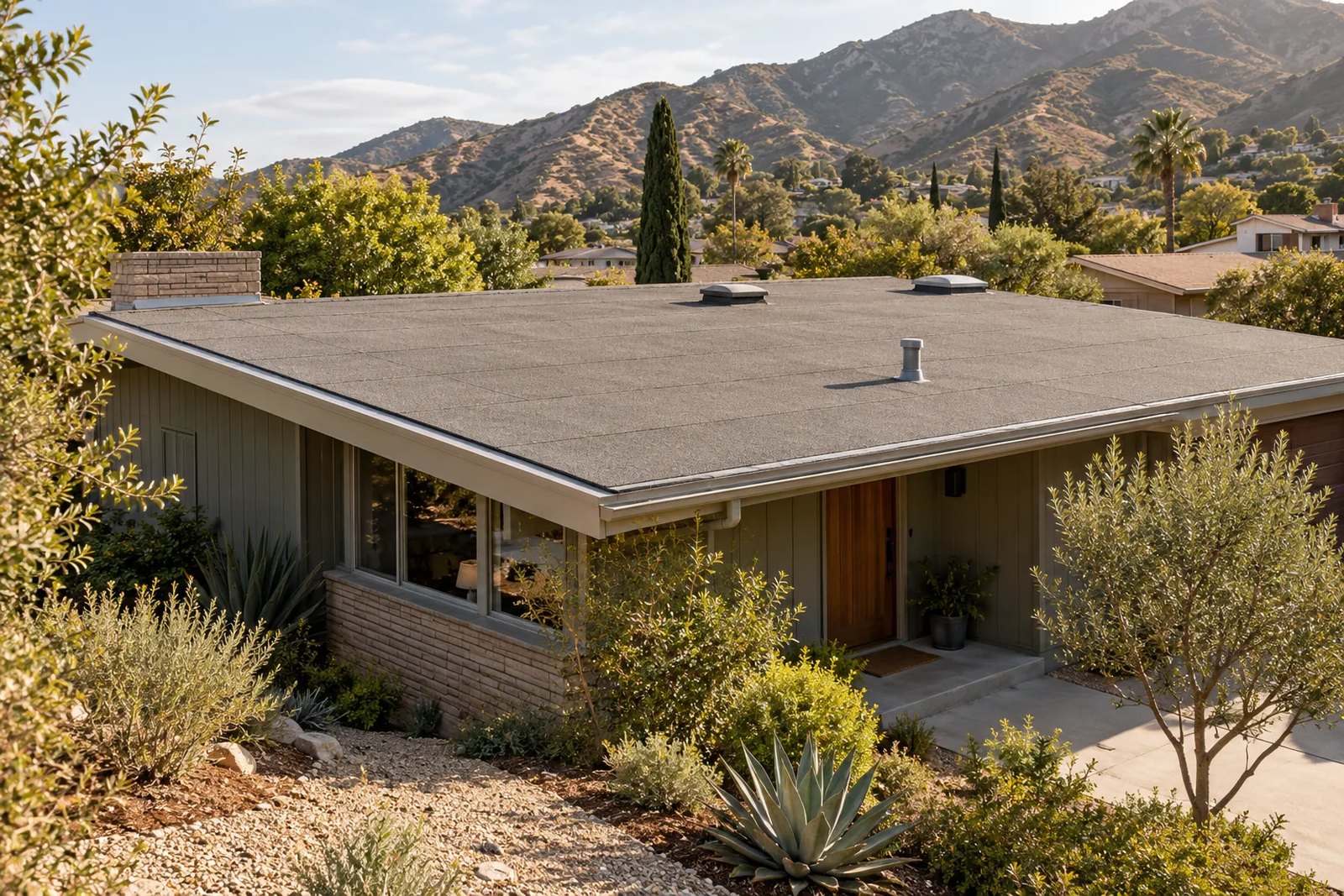 Low-slope mineral-surfaced roof on an illustrative Tujunga-style foothill home. Illustration, not a photograph of a completed Citium project.